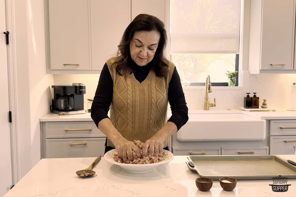 Mixing the meatball mixture with hands