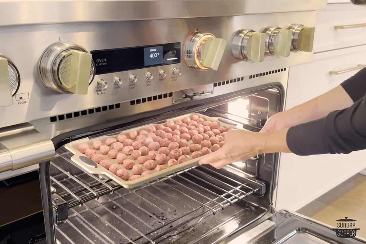 Adding the meatballs to the oven