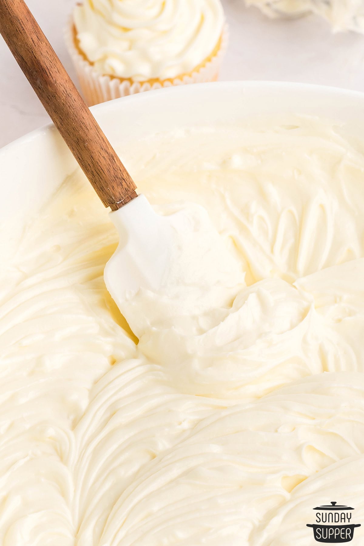 finished cream cheese frosting in a bowl with a spatula