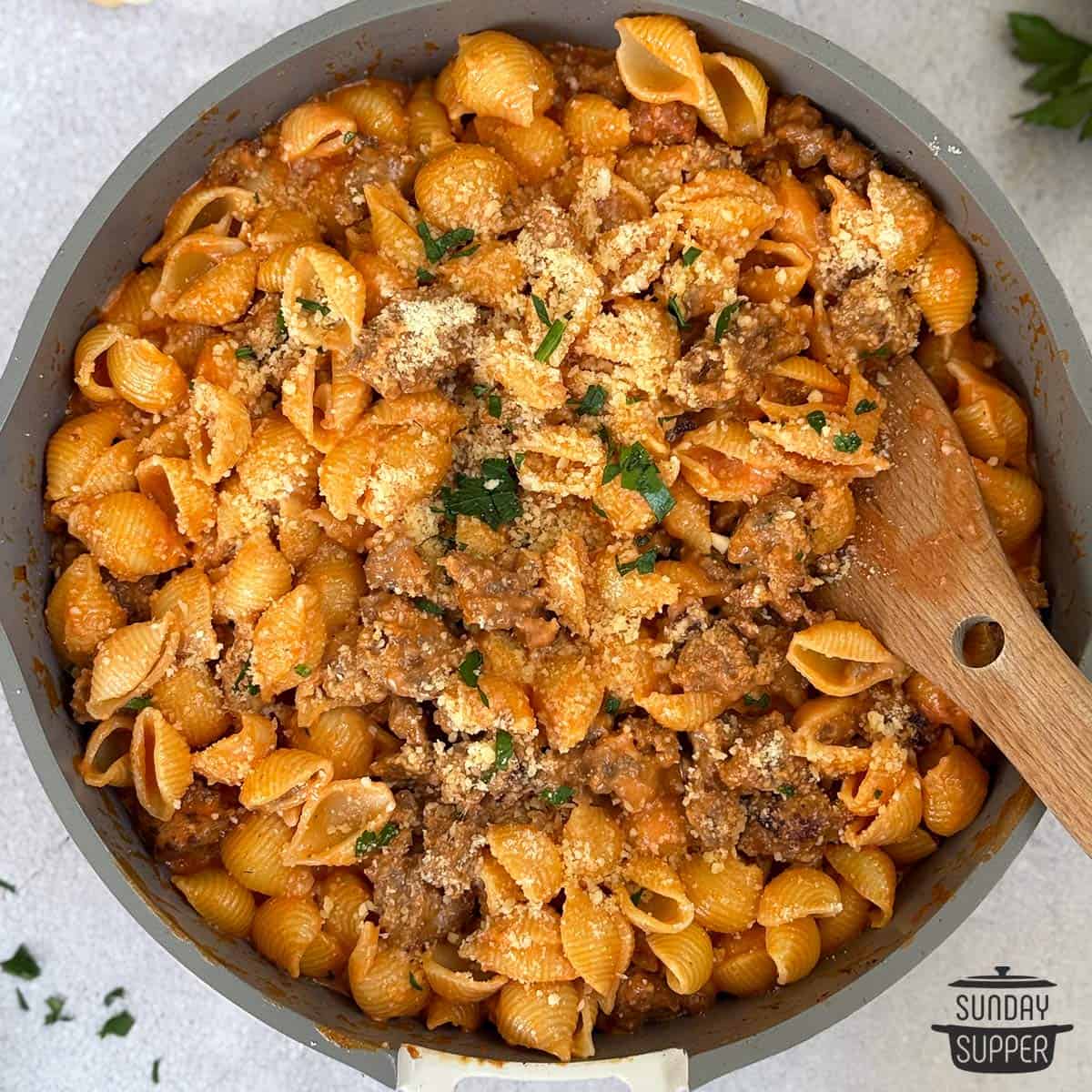 pink pasta with sausage in a pan