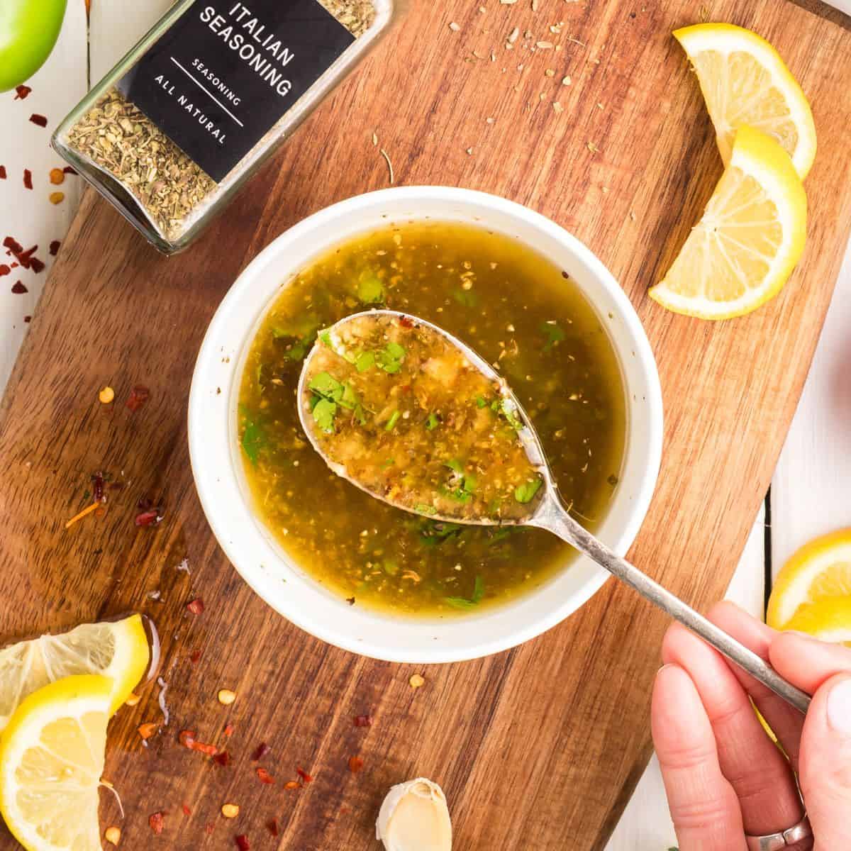 italian dressing in a bowl with a spoon