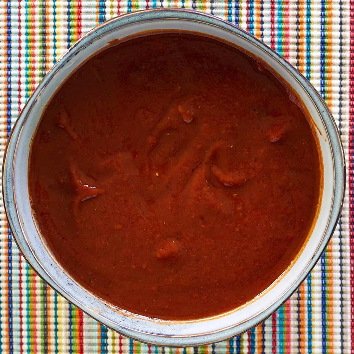 a bowl of red enchilada sauce