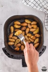 checking doneness of potatoes in air fryer