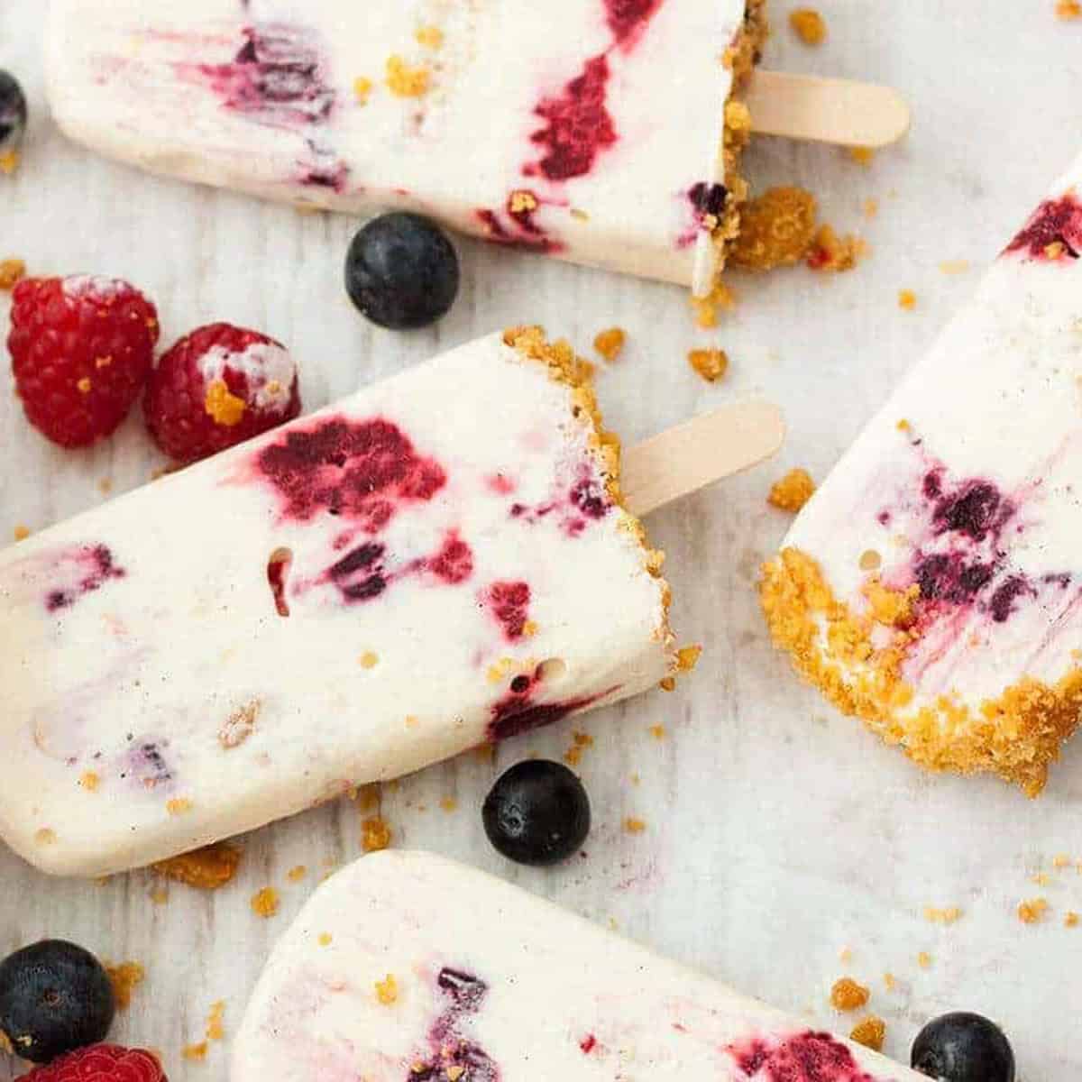 cheesecake popsicles with extra berries