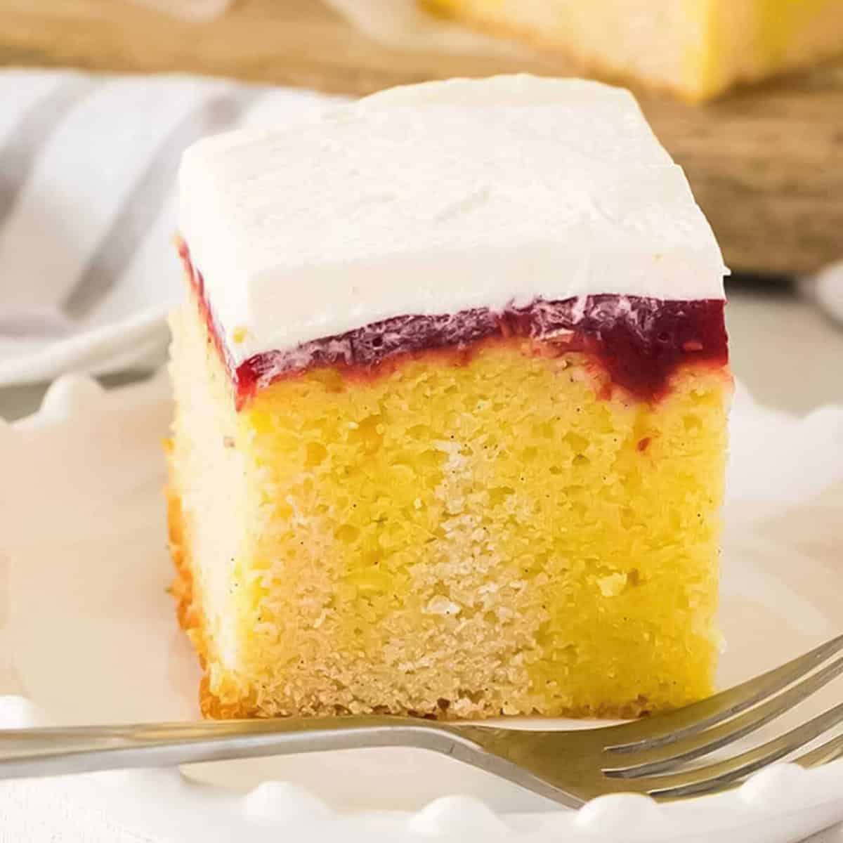 a slice of lemon poke cake showing the layers