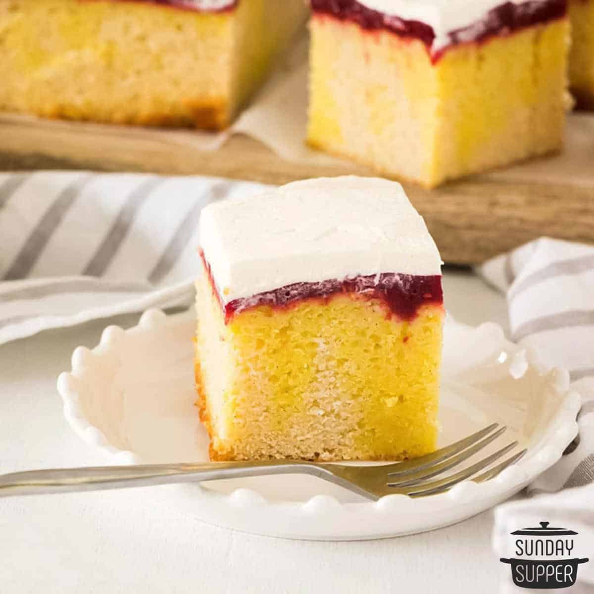 a slice of lemon jello poke cake