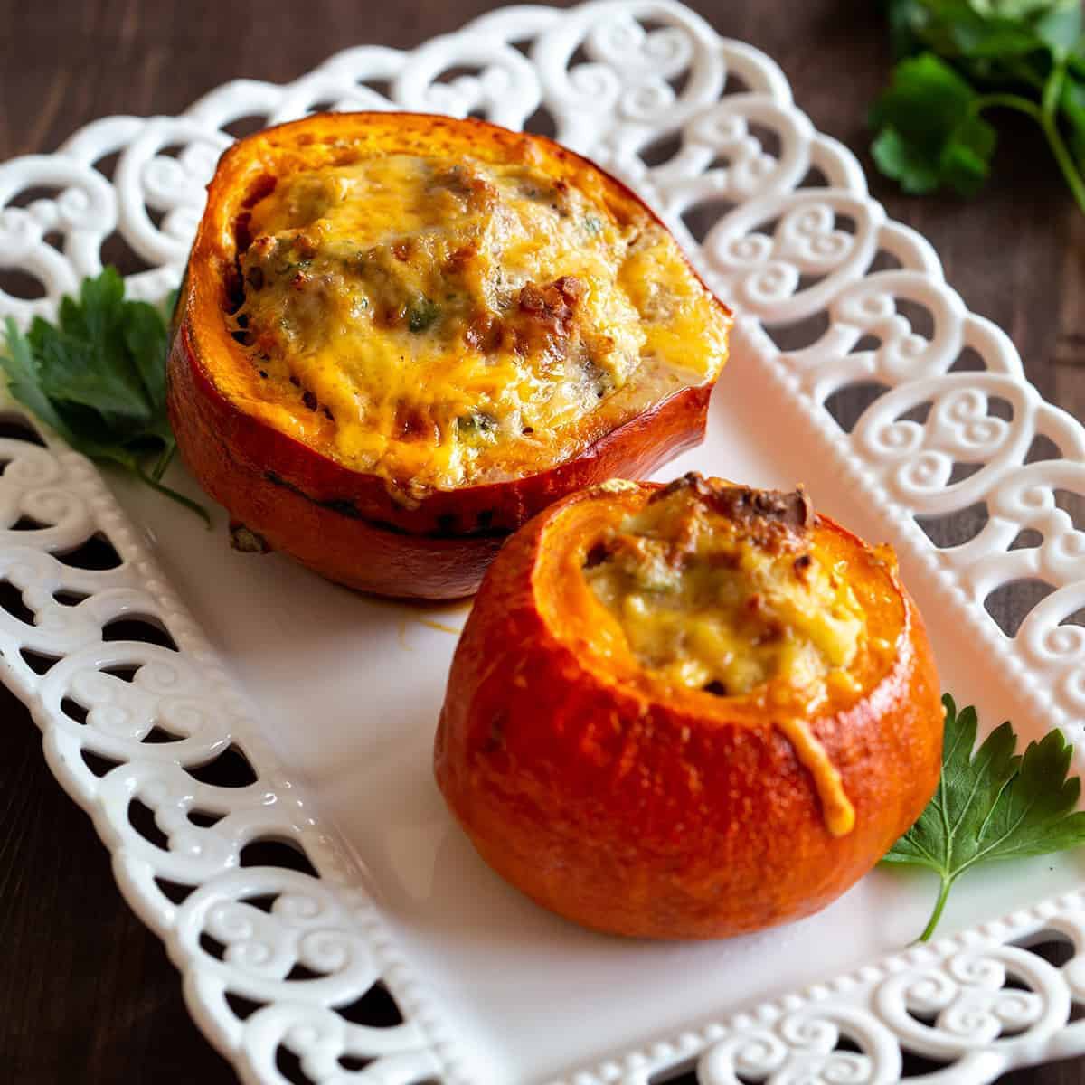 two stuffed squash on a serving platter