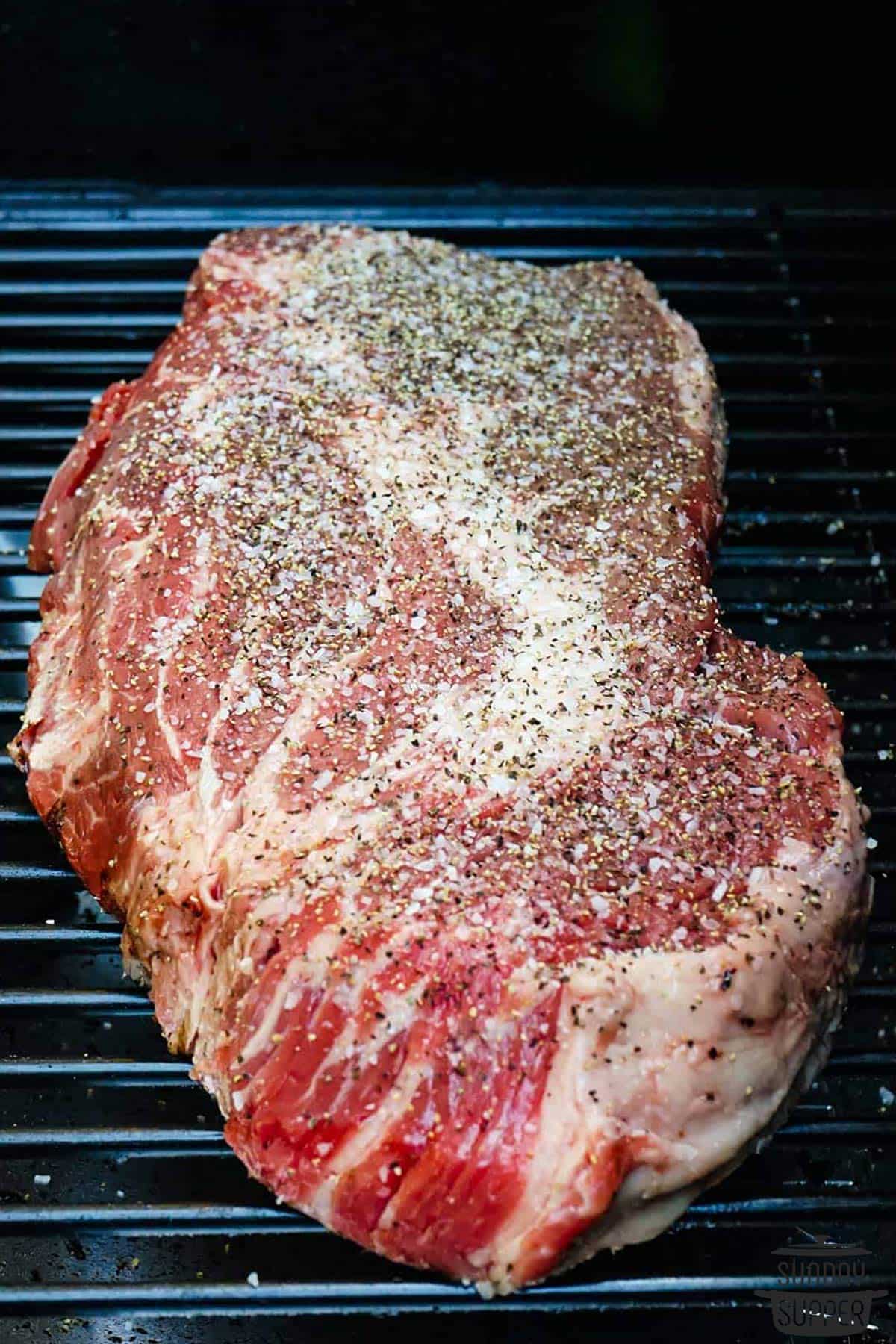 the seasoned chuck roast on the smoker grills
