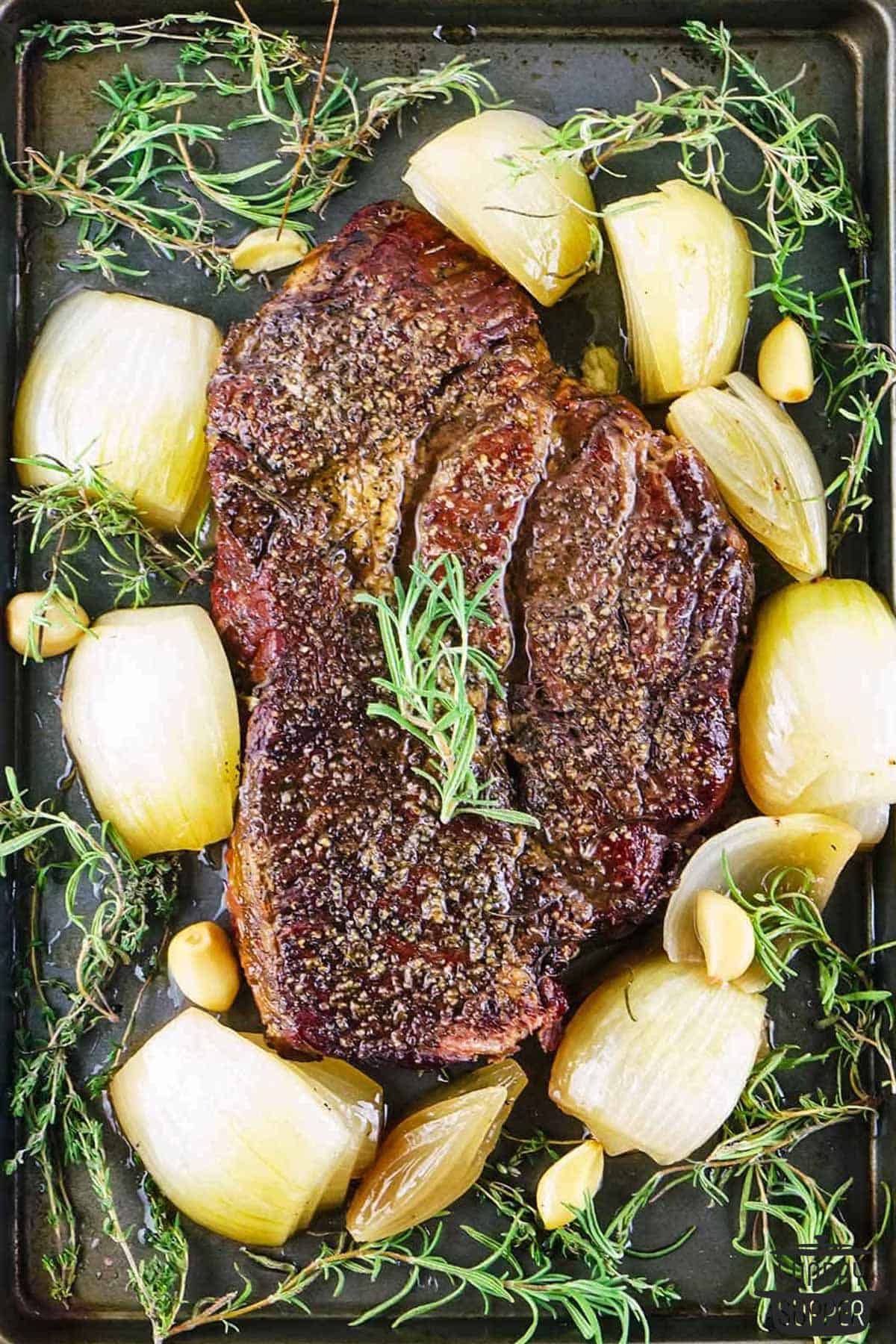the roast, onions, and herbs after roasting
