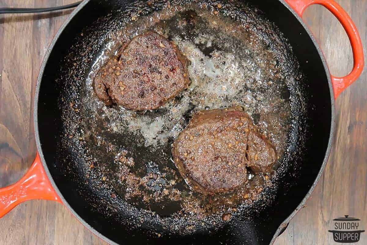 the steaks transferred to a cast iron pan to sear