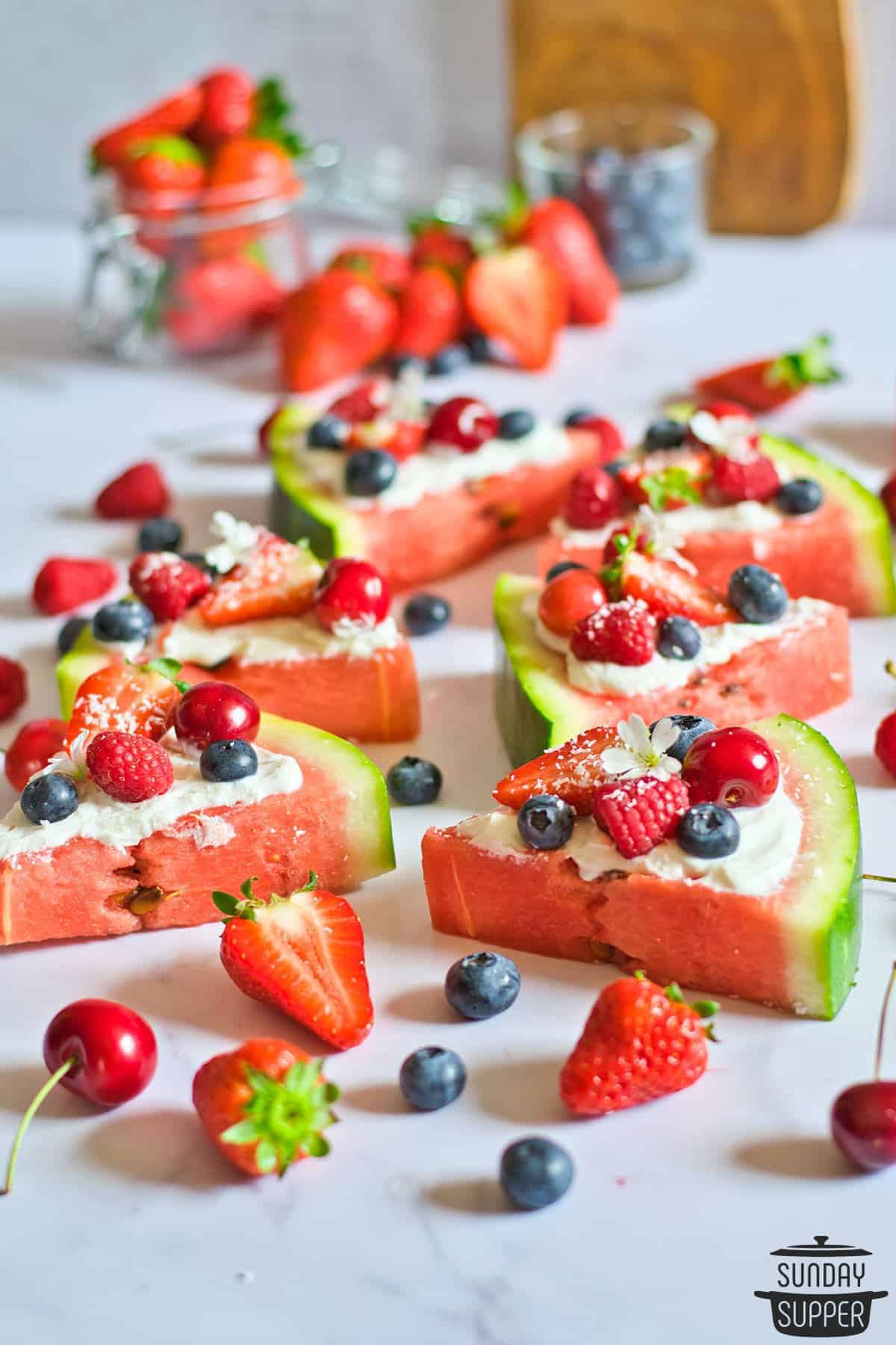 slices of watermelon pizza with extra berries
