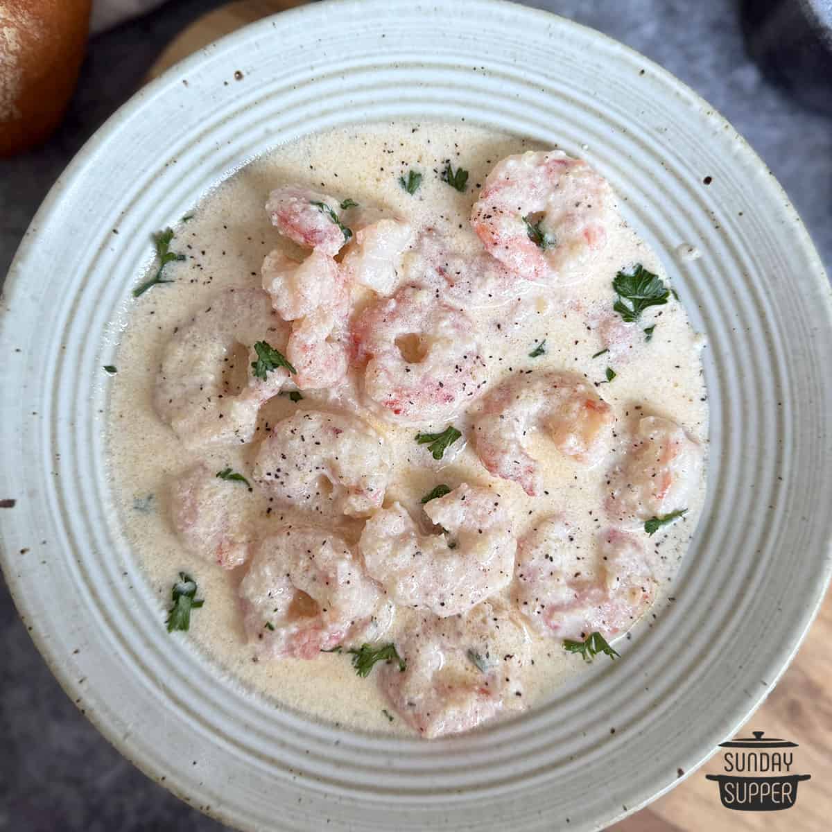 creamy garlic shrimp in a white shallow bowl