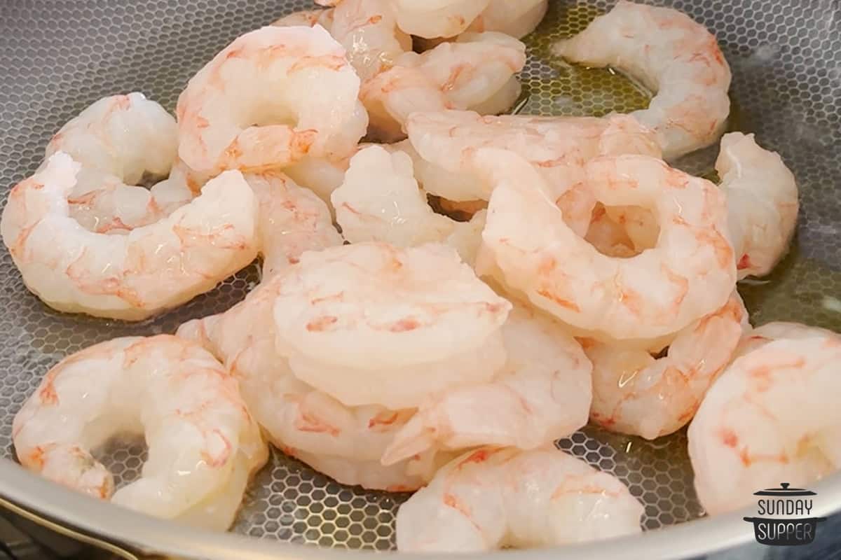 Adding the shrimp to the pan