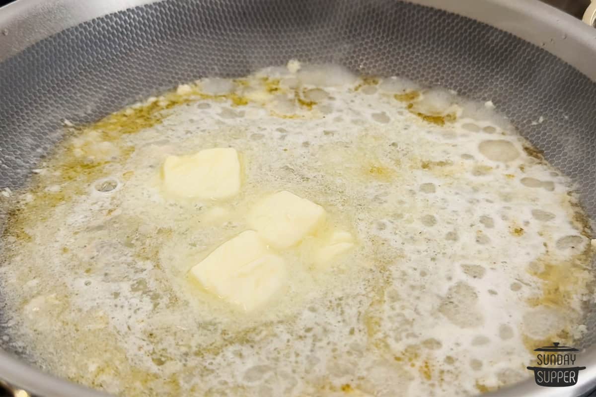 adding butter to the skillet