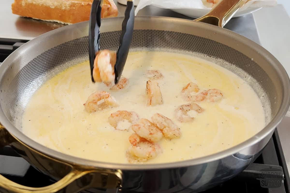 adding shrimp to the sauce