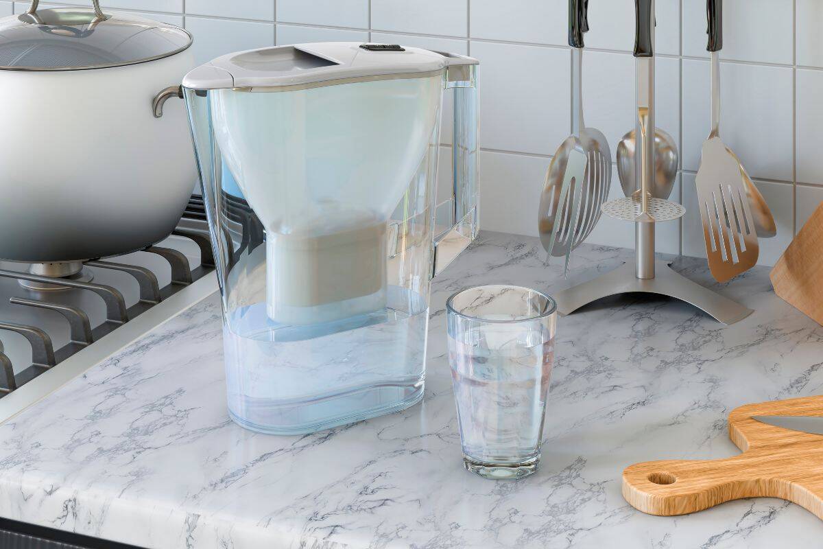 water filter pitcher next to a glass of water
