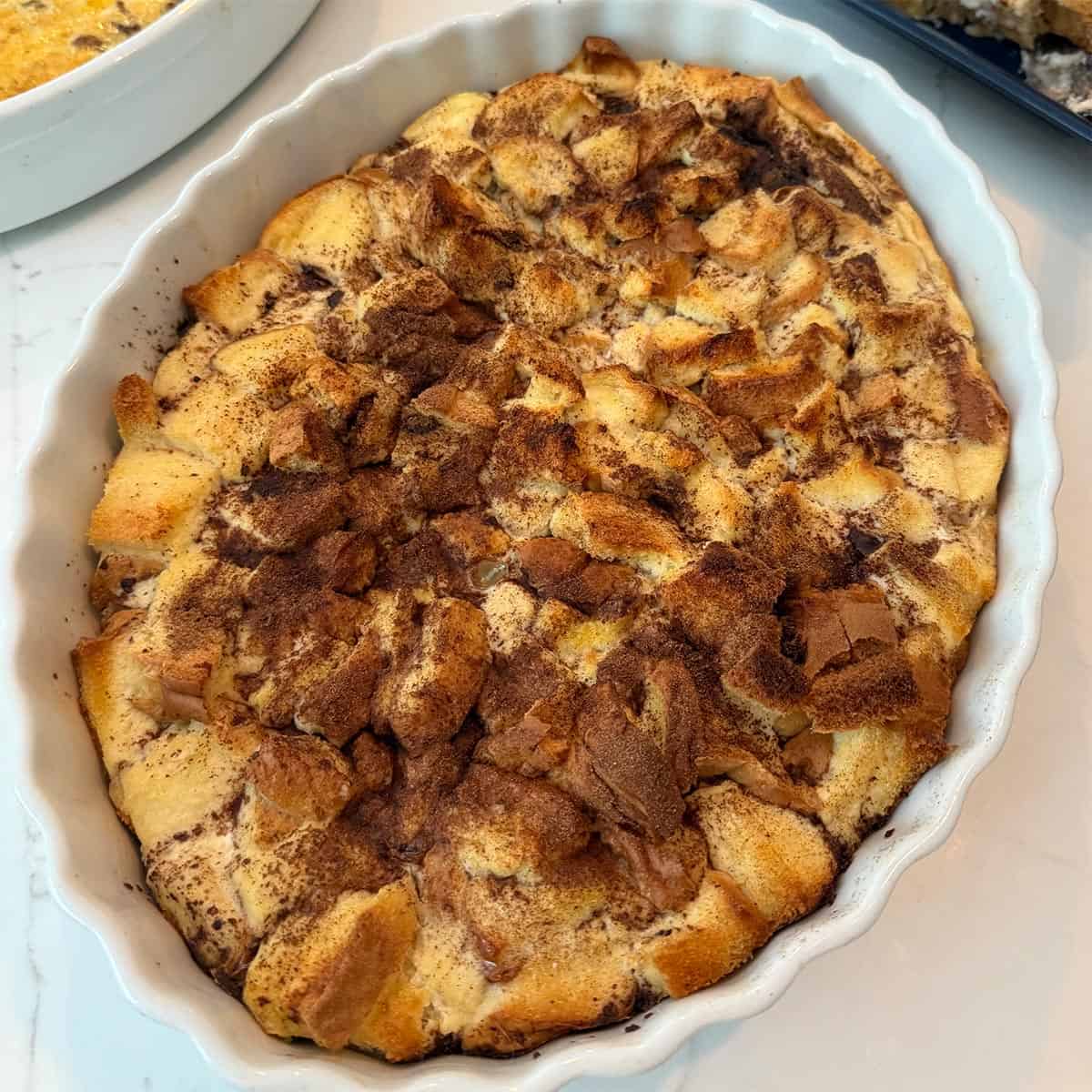 french toast casserole in a white baking dish