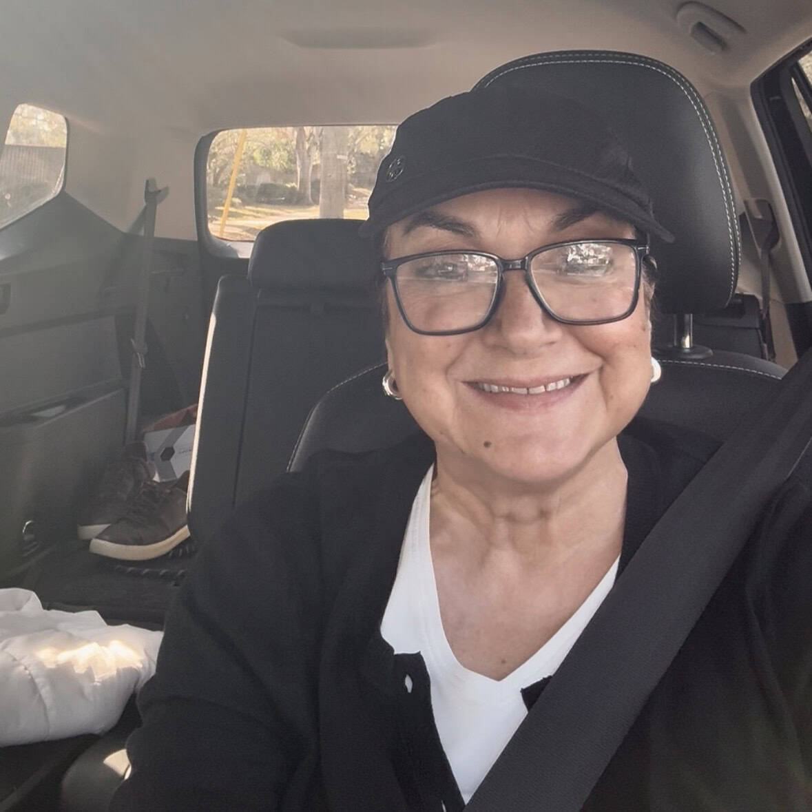 isabel in the car ready to go to an estate sale